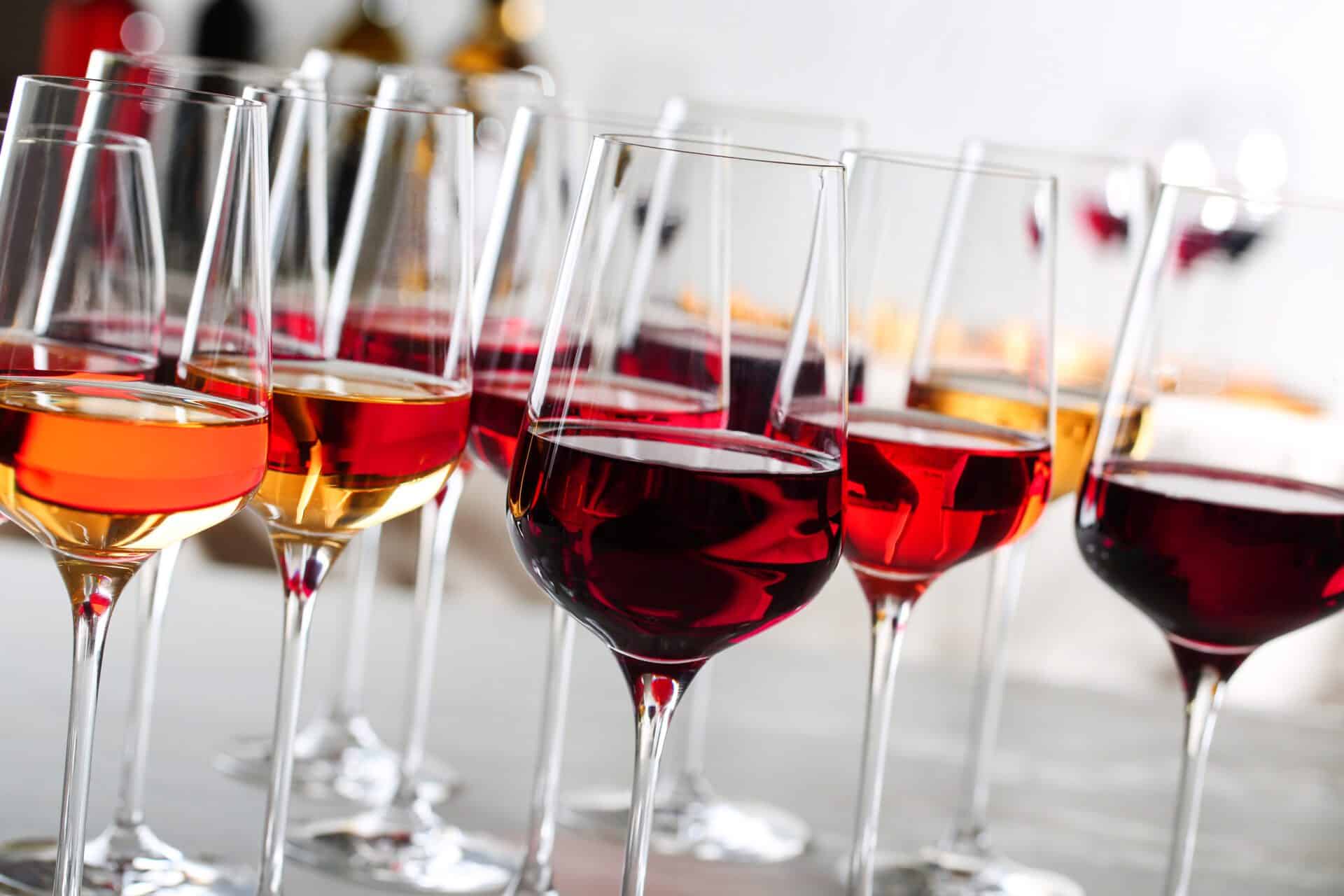 Glasses,With,Different,Wines,On,Blurred,Background,,Closeup